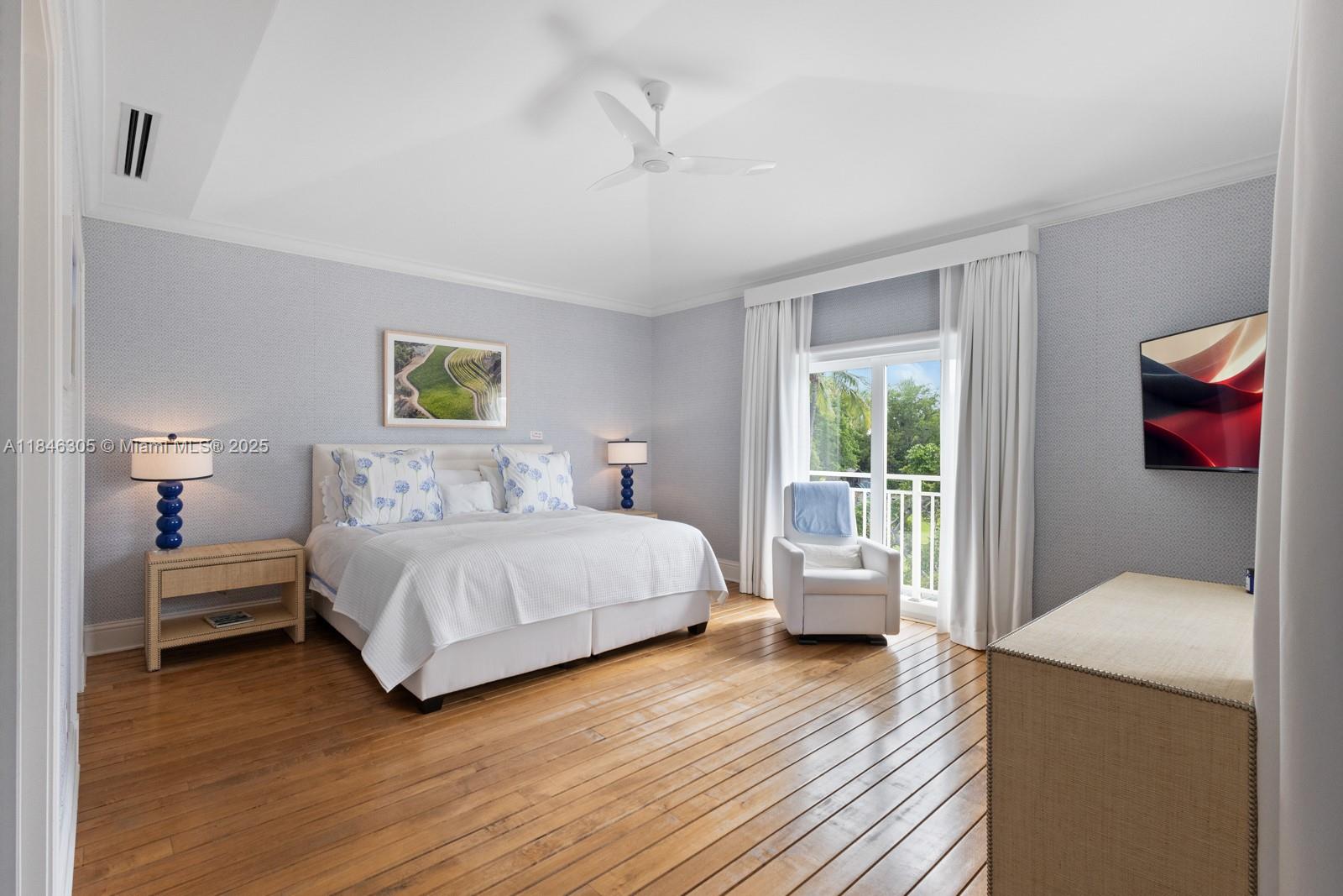 5 Coconut Lane Key Biscayne, FL 33149 - Photo 26 of 41 a bedroom with a bed and wooden floor