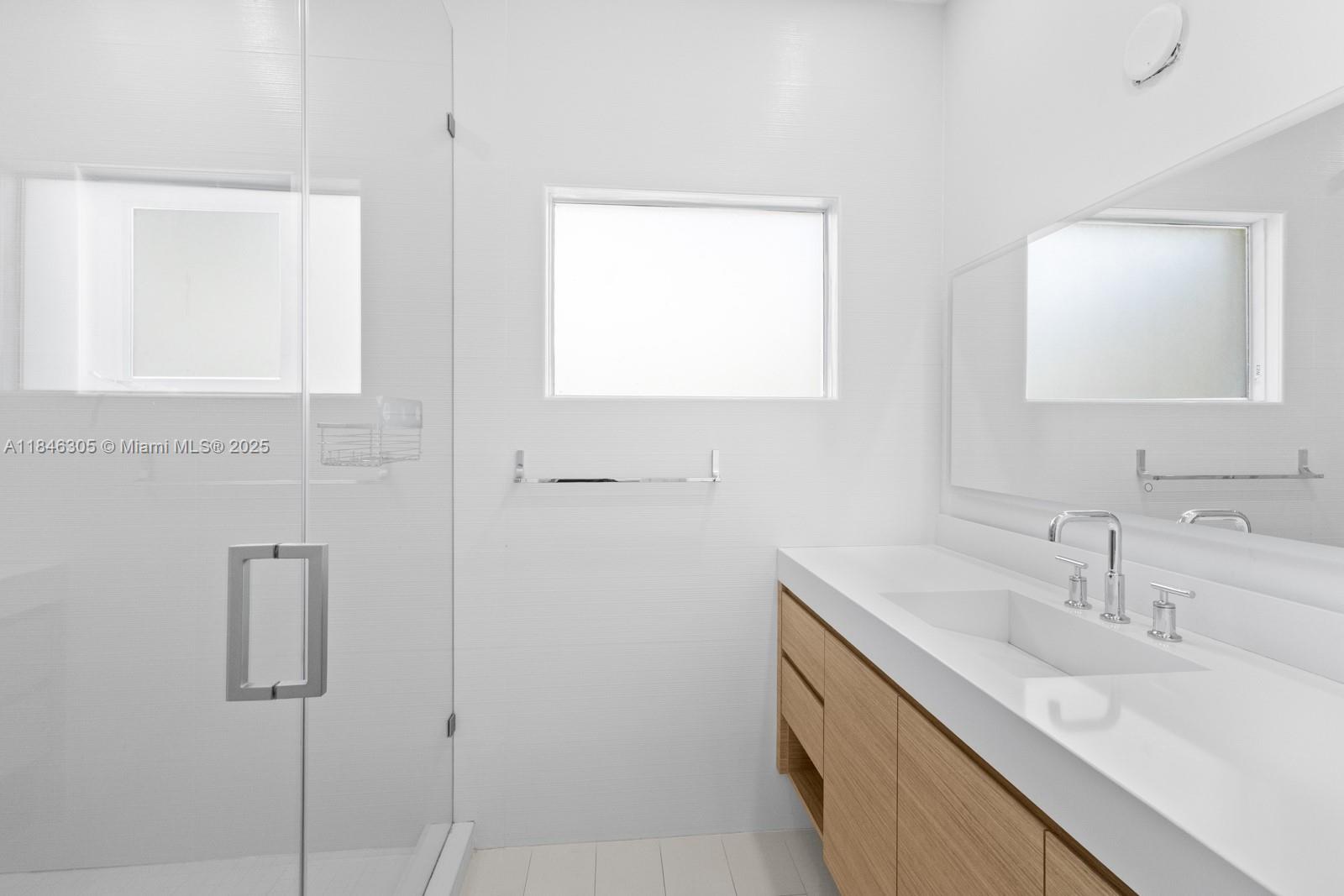 5 Coconut Lane Key Biscayne, FL 33149 - Photo 29 of 41 a bathroom with a sink a vanity and a mirror