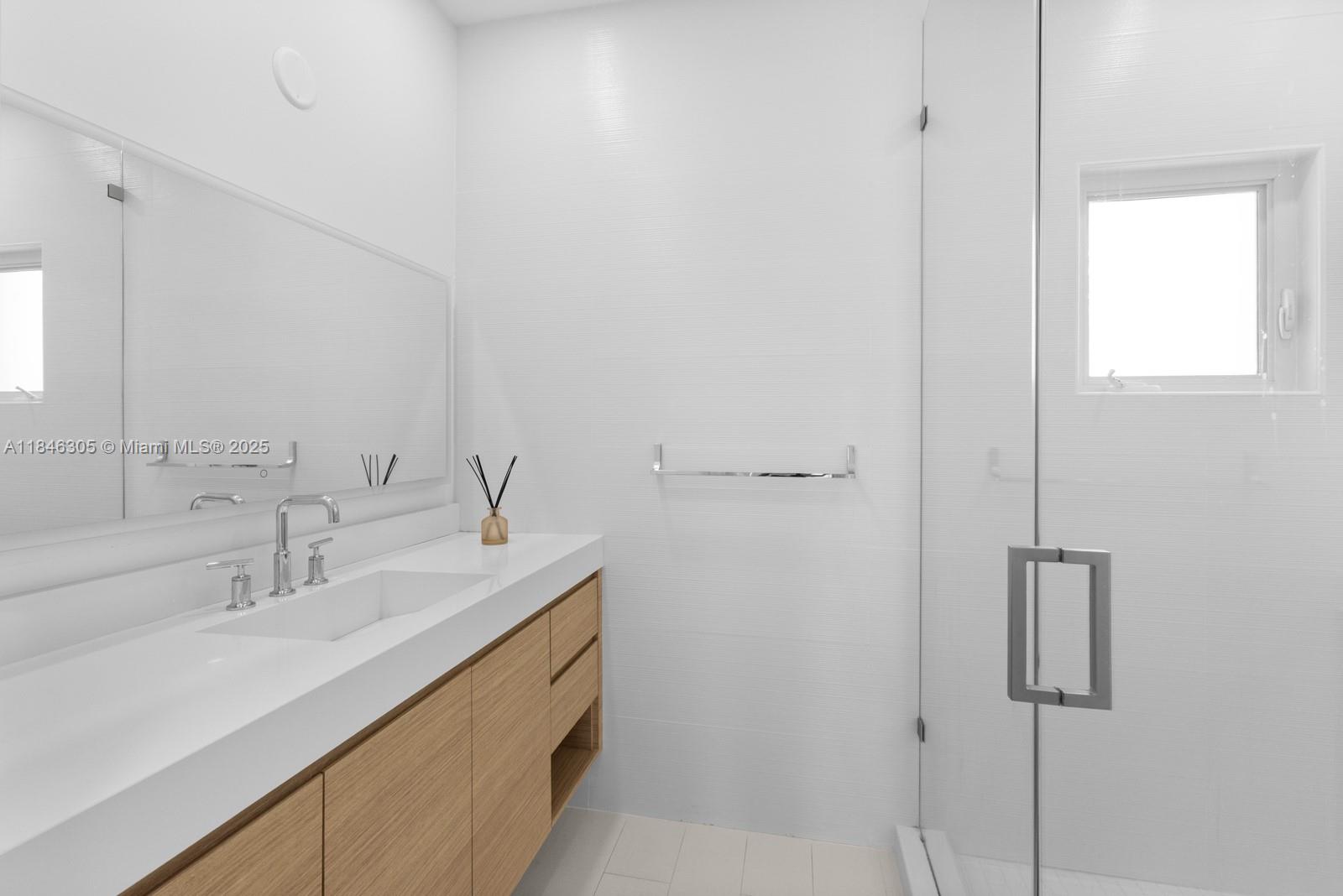 5 Coconut Lane Key Biscayne, FL 33149 - Photo 31 of 41 a bathroom with a sink and a mirror