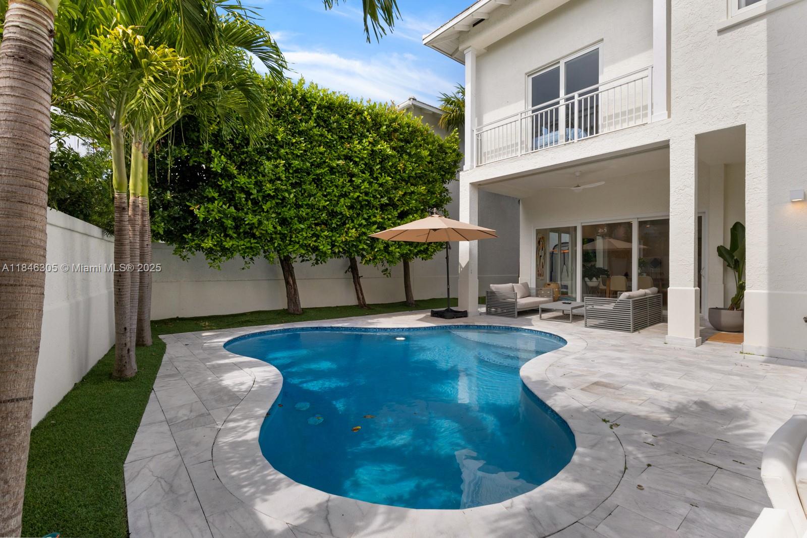 5 Coconut Lane Key Biscayne, FL 33149 - Photo 34 of 41 a view of a house with swimming pool and sitting area