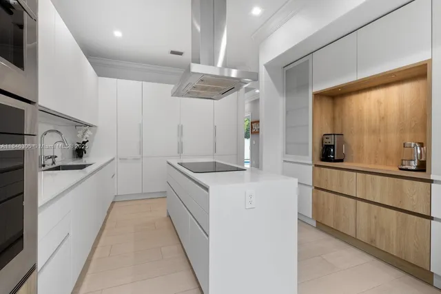 a kitchen with granite countertop a sink stainless steel appliances and cabinets