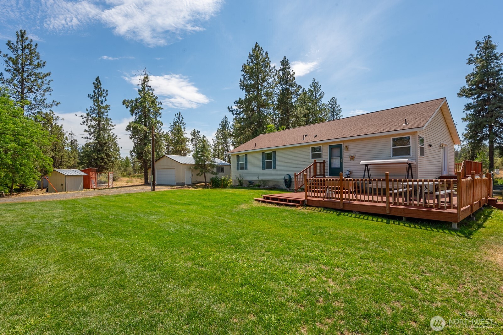 a view of a house with a backyard and a patio