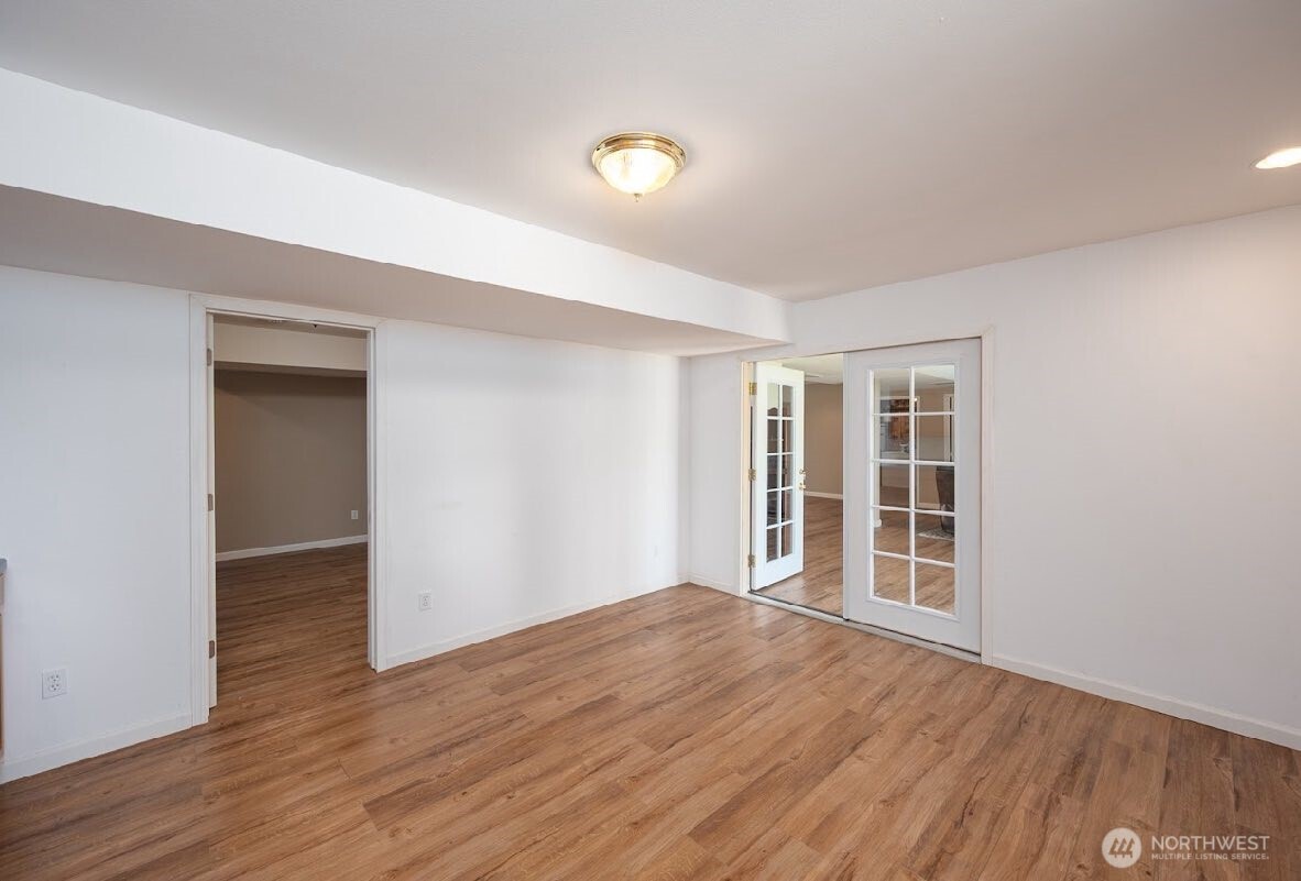 2207 West Depot Springs Road Spangle, WA 99031 - Photo 21 of 26 a view of an empty room with wooden floor and a window