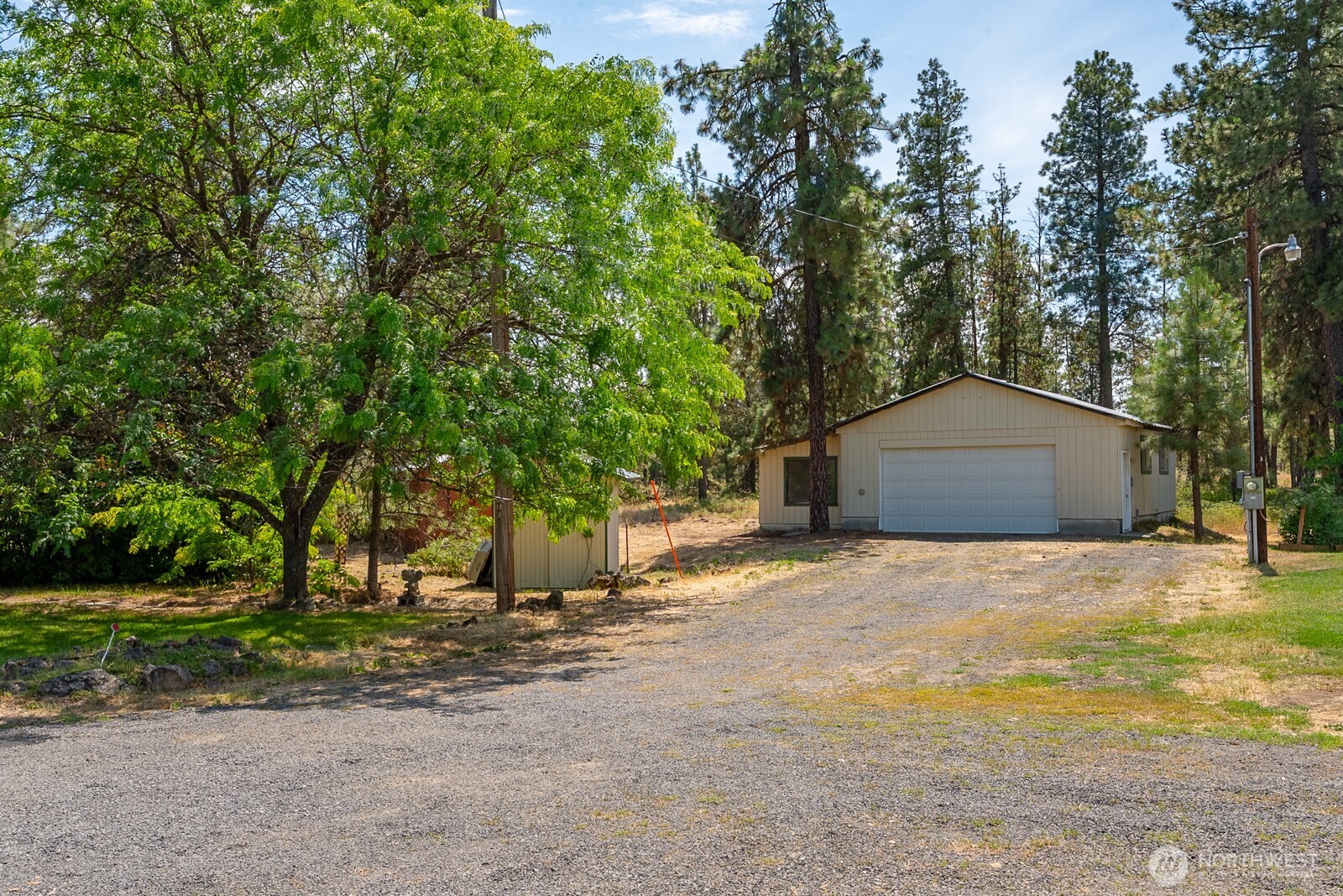 2207 West Depot Springs Road Spangle, WA 99031 - Photo 24 of 26 a tall house with trees in front of it