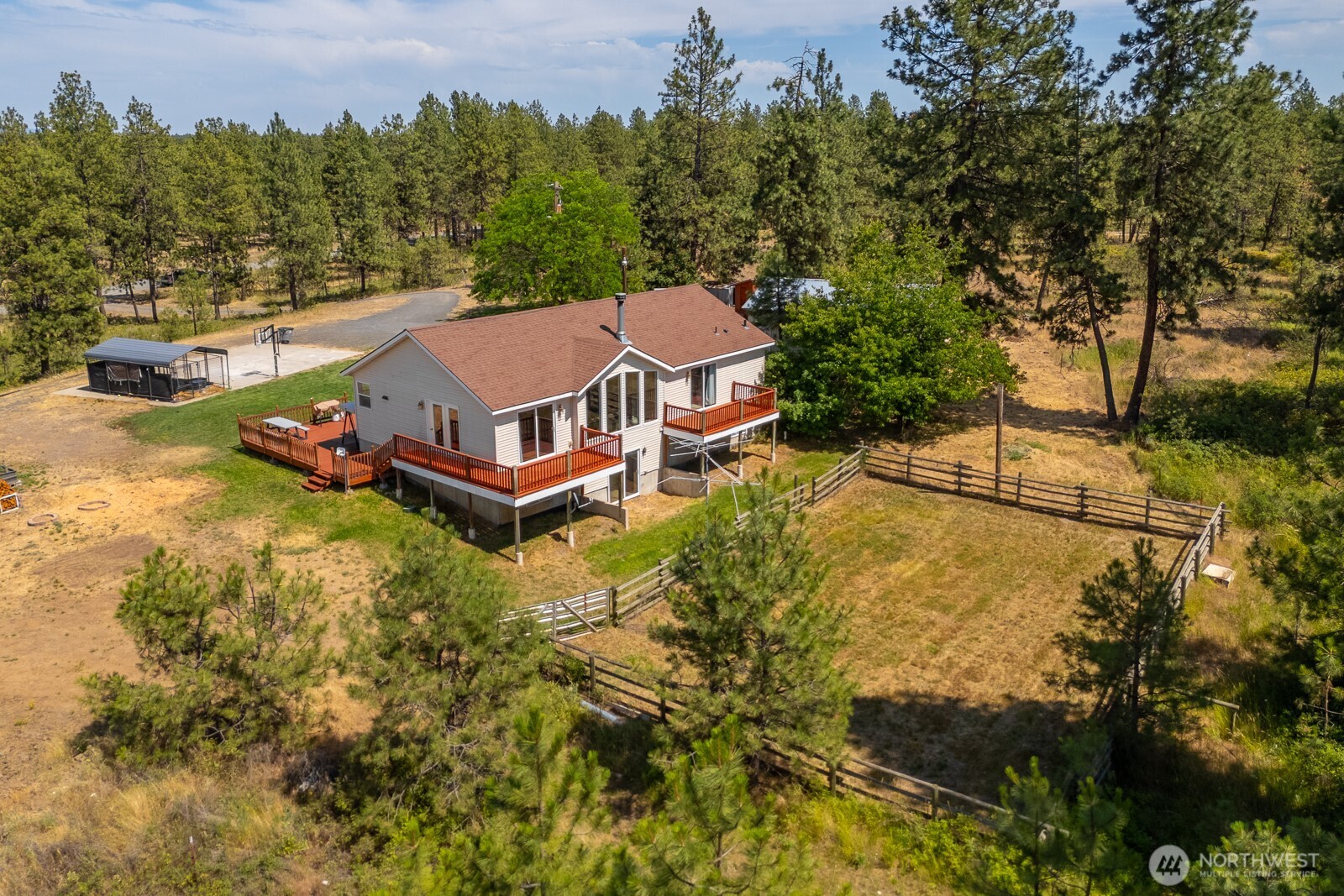 2207 West Depot Springs Road Spangle, WA 99031 - Photo 5 of 26 an aerial view of a house with swimming pool and trees