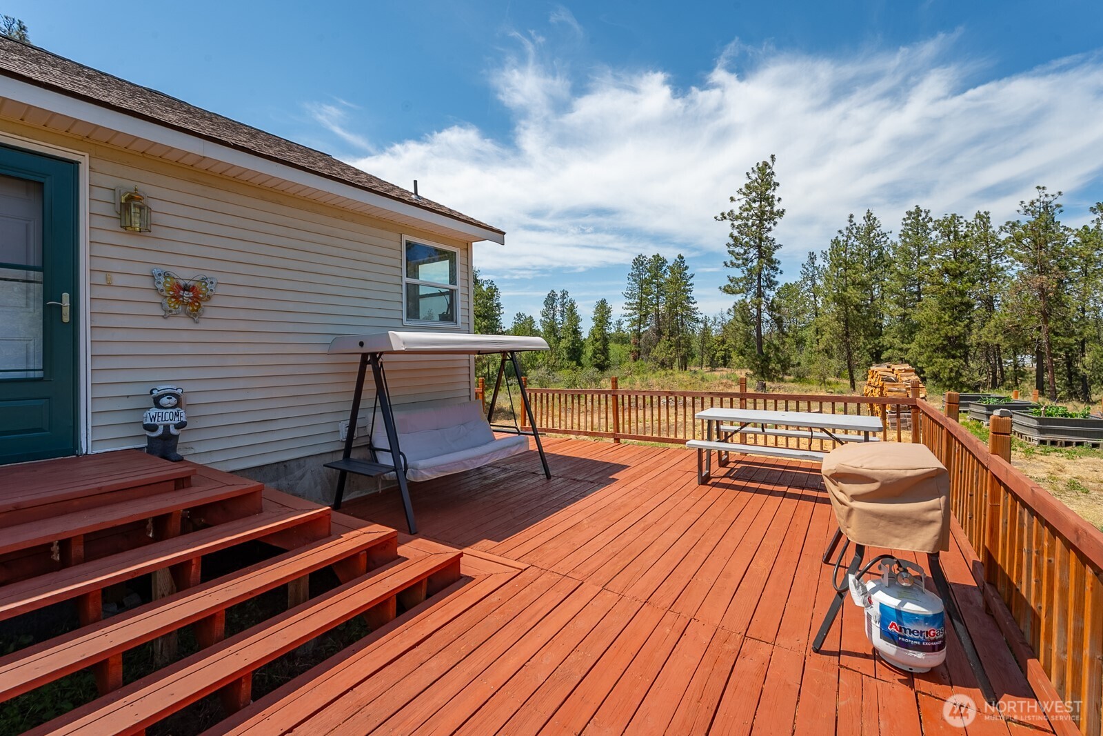 2207 West Depot Springs Road Spangle, WA 99031 - Photo 8 of 26 a balcony with wooden floor and outdoor seating