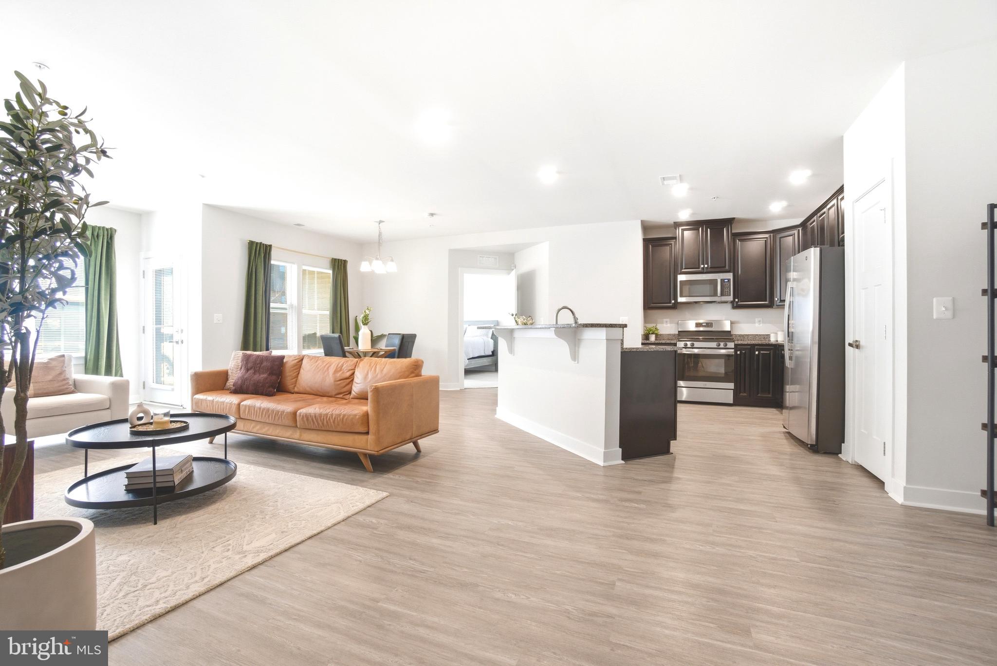 a living room with furniture and kitchen view