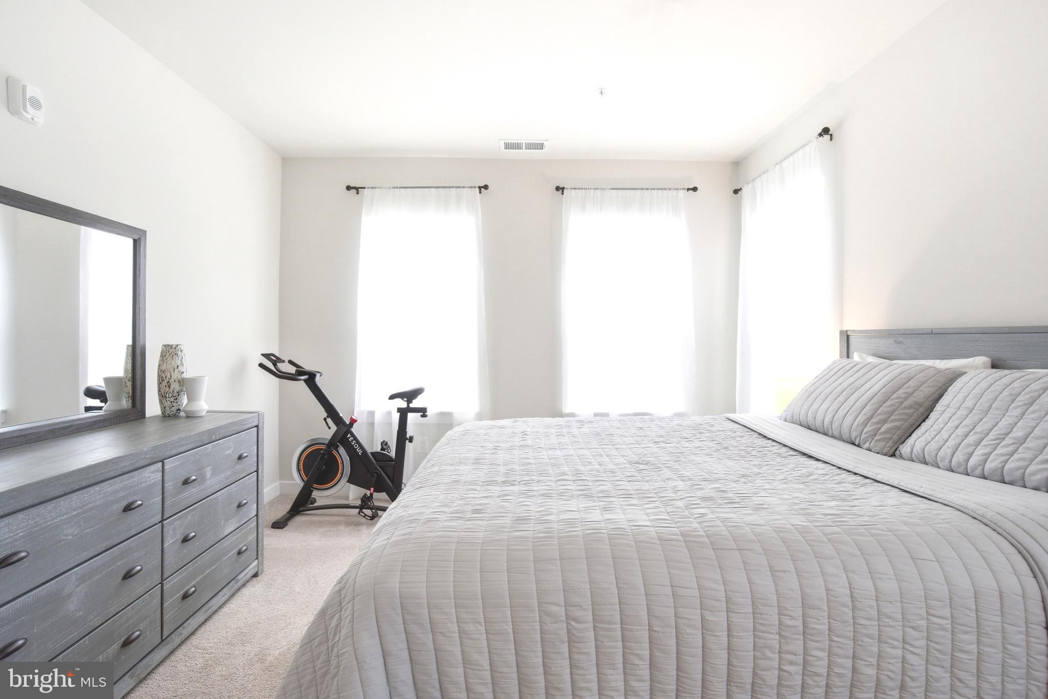 10020 Ruffian Way, Unit A Laurel, MD 20723 - Photo 13 of 36 a bedroom with a bed and a dresser