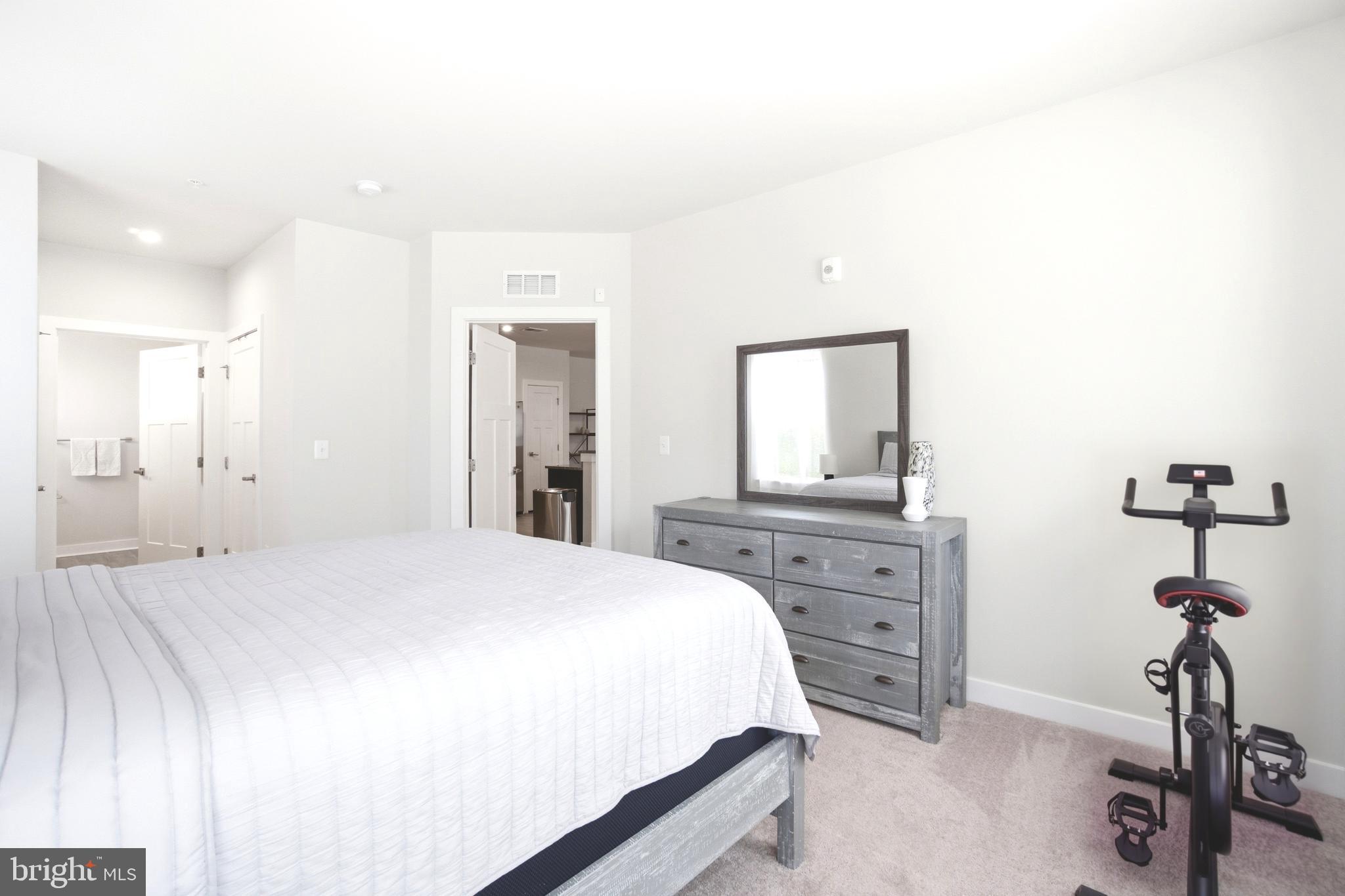 10020 Ruffian Way, Unit A Laurel, MD 20723 - Photo 14 of 36 a bedroom with a bed and a chandelier