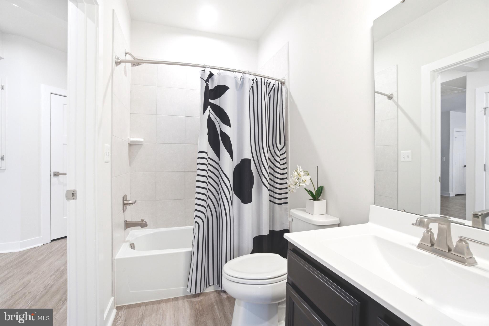 10020 Ruffian Way, Unit A Laurel, MD 20723 - Photo 15 of 36 a bathroom with a sink a toilet and a bathtub