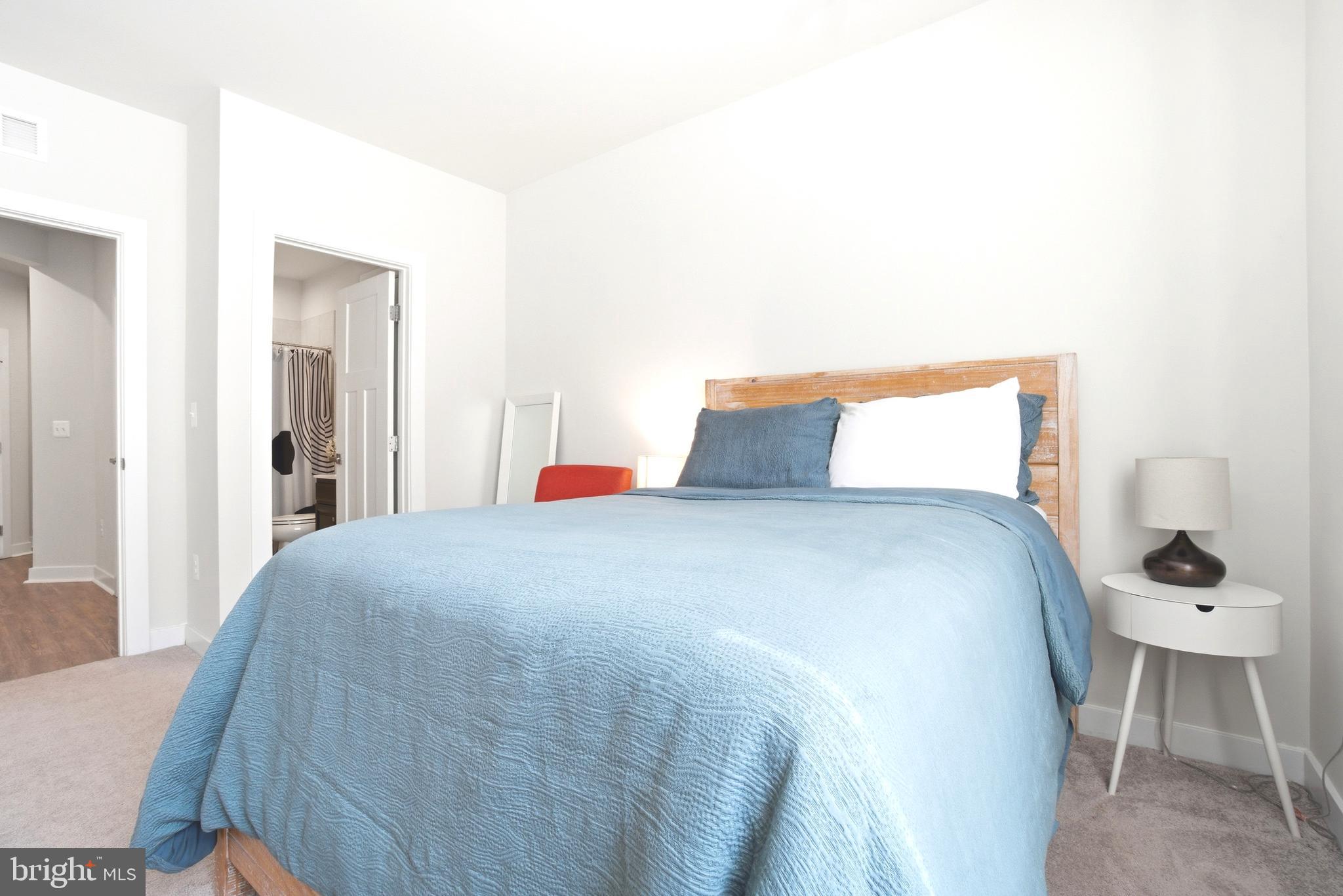 10020 Ruffian Way, Unit A Laurel, MD 20723 - Photo 20 of 36 a bedroom with a bed and chair