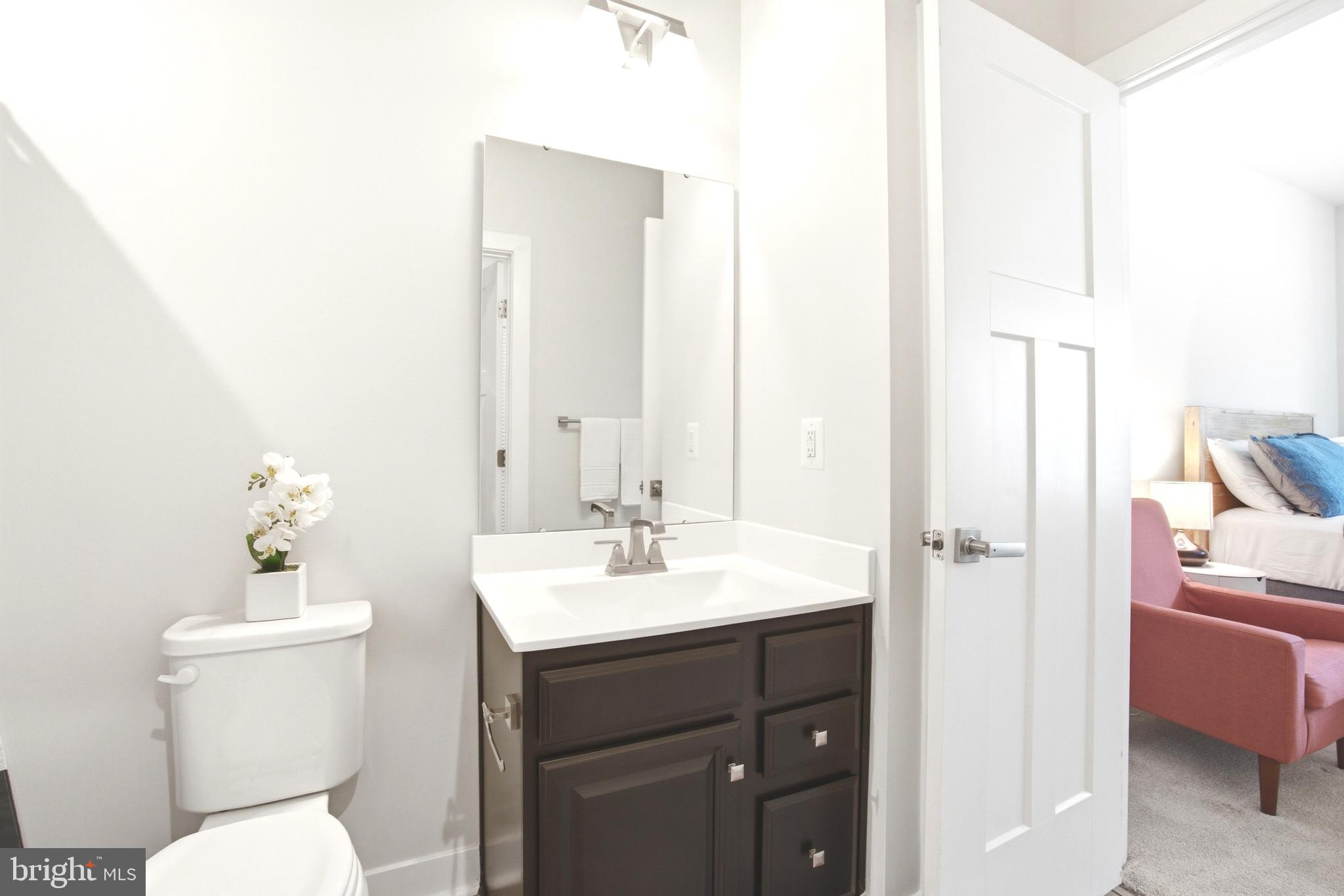 10020 Ruffian Way, Unit A Laurel, MD 20723 - Photo 21 of 36 a bathroom with a toilet sink and mirror