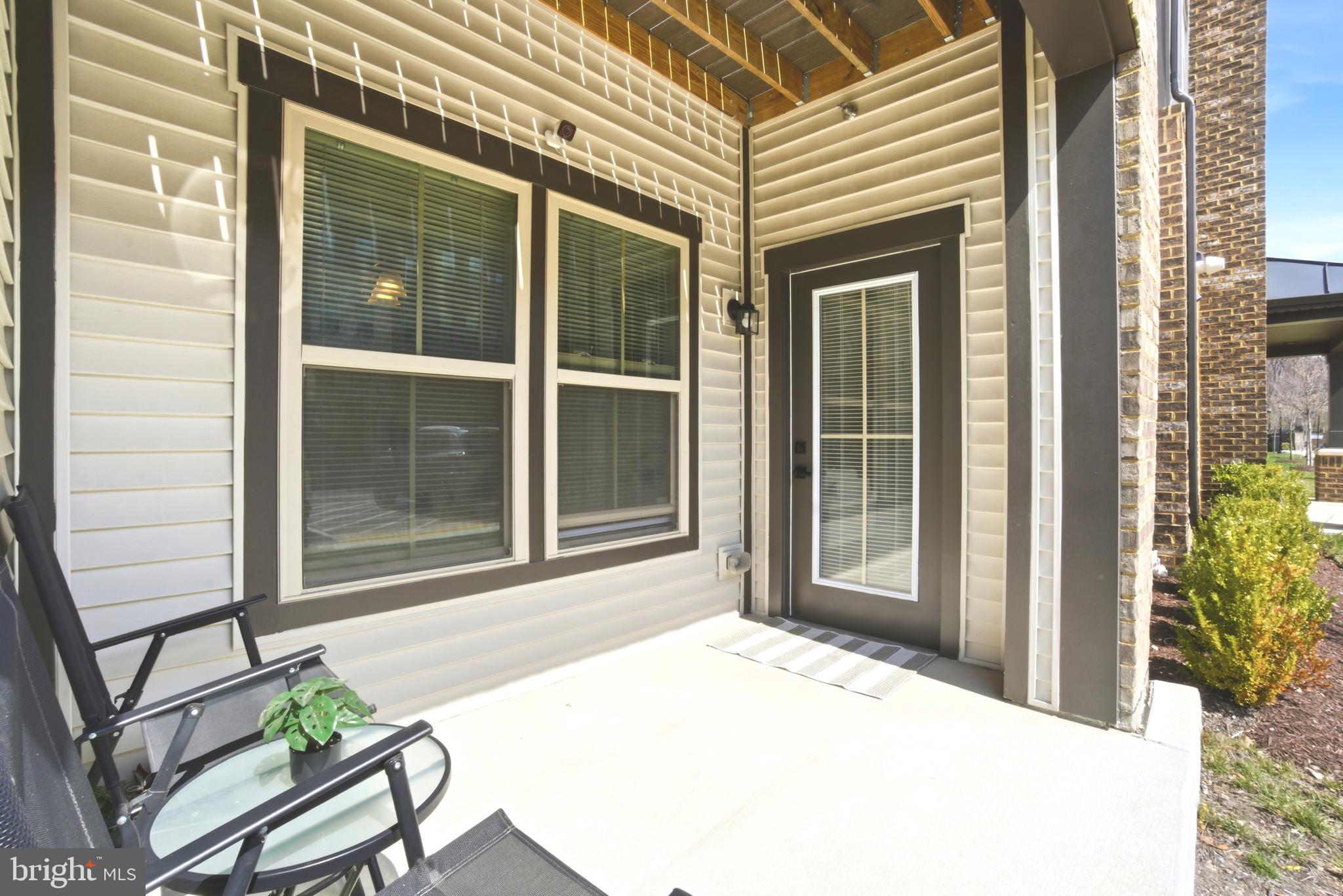 10020 Ruffian Way, Unit A Laurel, MD 20723 - Photo 23 of 36 a view of a porch with a table and chairs and potted plants