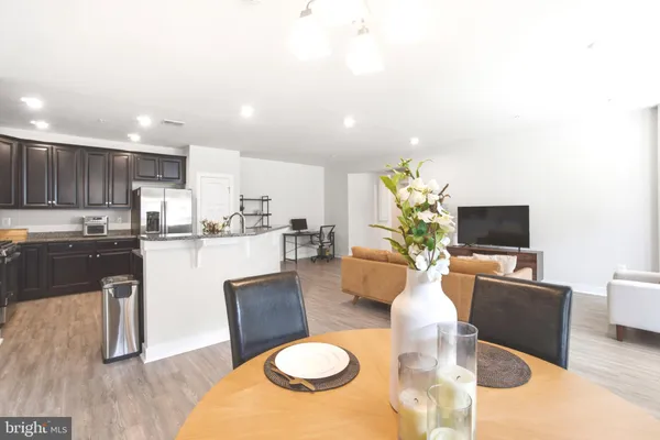 a living room with kitchen island furniture and a flat screen tv