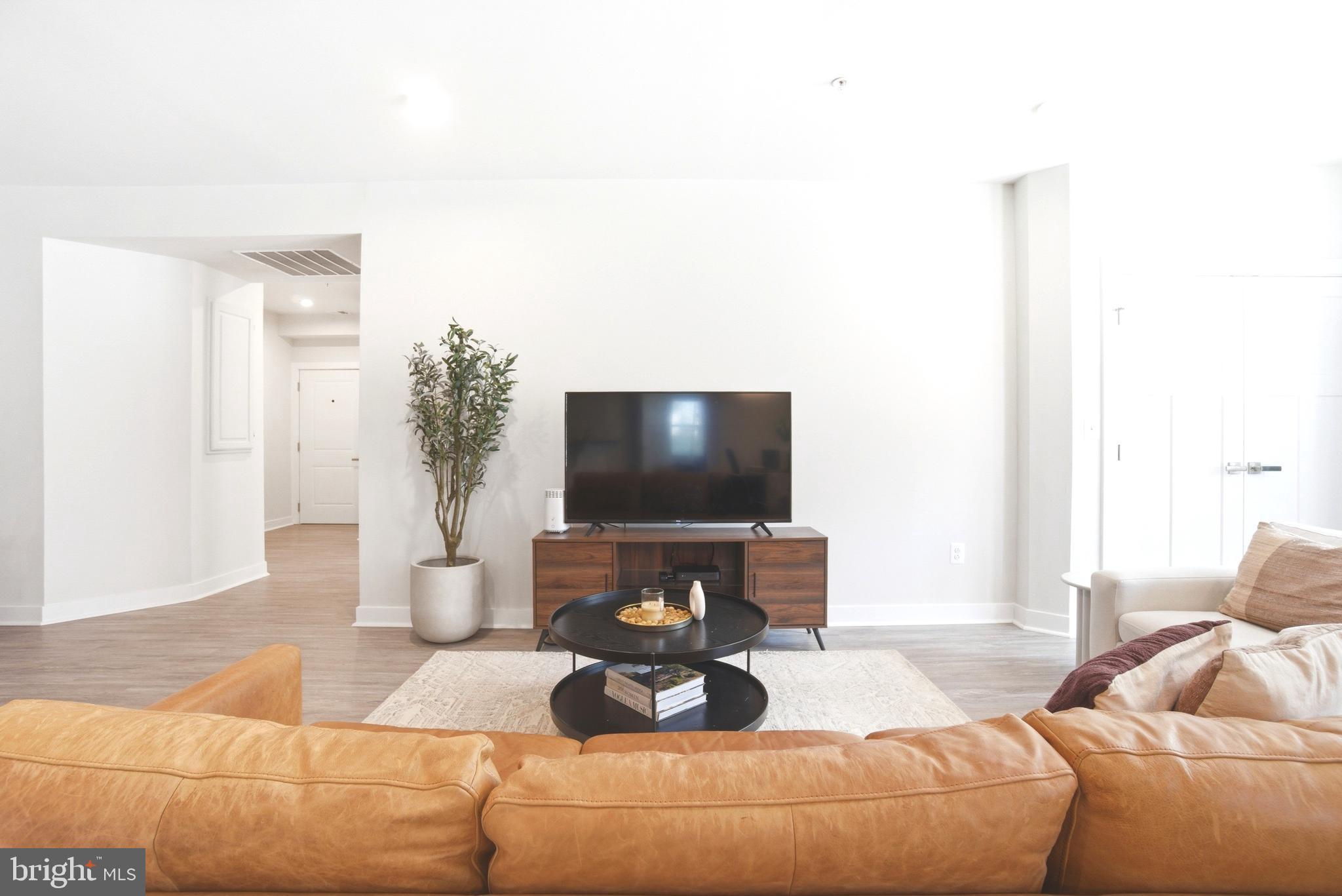 10020 Ruffian Way, Unit A Laurel, MD 20723 - Photo 5 of 36 a living room with furniture and a flat screen tv