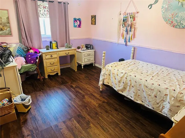 a living room with furniture a window and a flat screen tv
