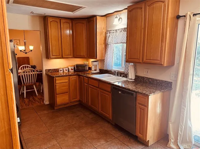 a kitchen with stainless steel appliances granite countertop a refrigerator stove and sink