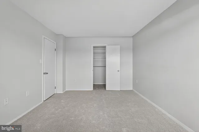 a view of an empty room and a window