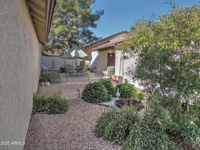 a backyard of a house with outdoor seating and green space