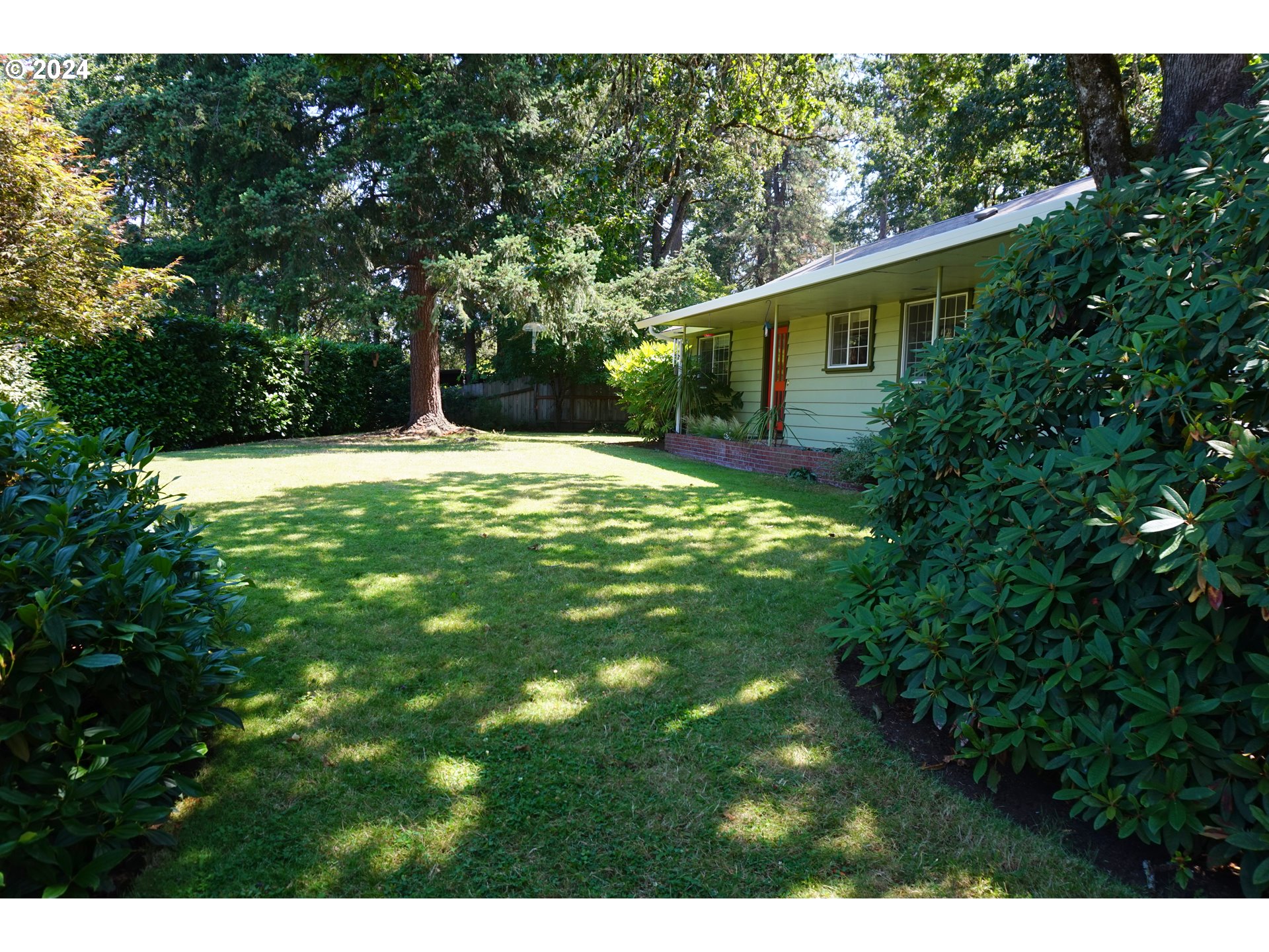 a backyard of a house with lots of green space