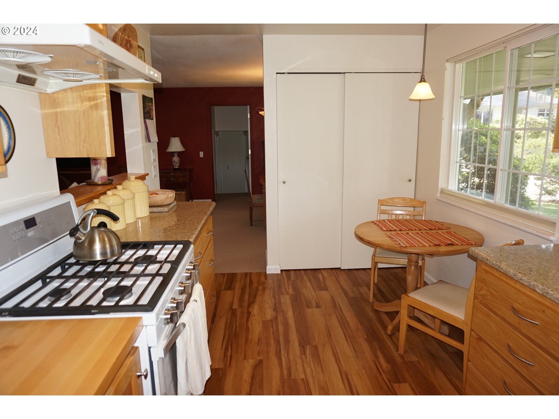 3055 Charnelton Street Eugene, OR 97405 - Photo 16 of 45 a kitchen with a stove a refrigerator and a dining table