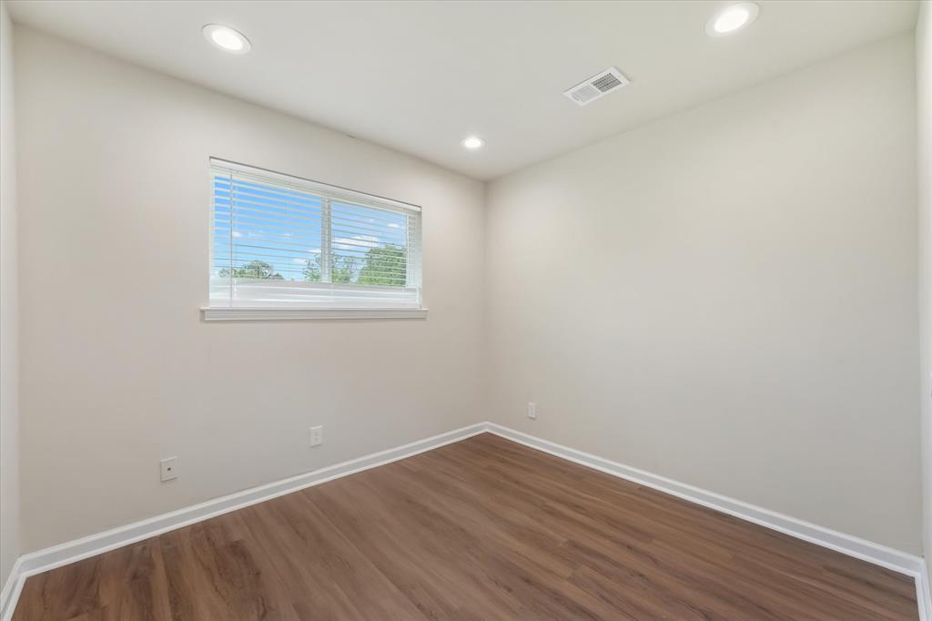 304 East Stone Road Wylie, TX 75098 - Photo 13 of 19 an empty room with wooden floor and windows