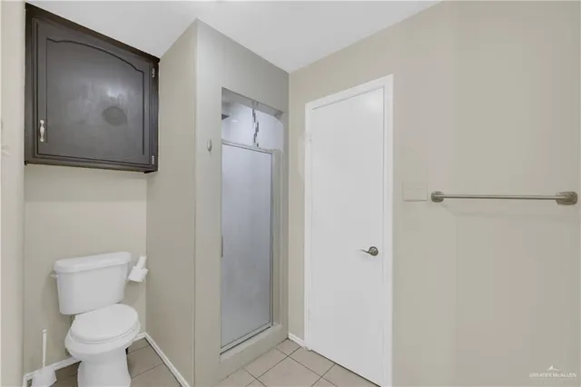a white toilet sitting next to a bathroom sink