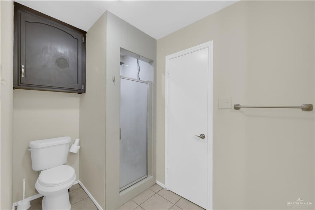 2401 South Jackson Road, Unit 9 Pharr, TX 78577 - Photo 11 of 17 a white toilet sitting next to a bathroom sink