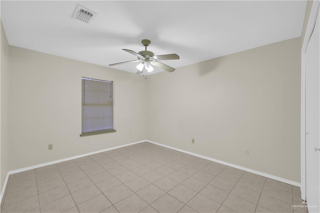 2401 South Jackson Road, Unit 9 Pharr, TX 78577 - Photo 13 of 17 wooden floor in an empty room with a window
