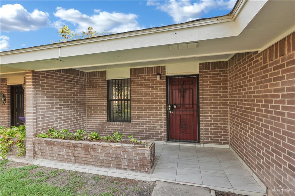 2401 South Jackson Road, Unit 9 Pharr, TX 78577 - Photo 3 of 17 a front view of a house with a yard