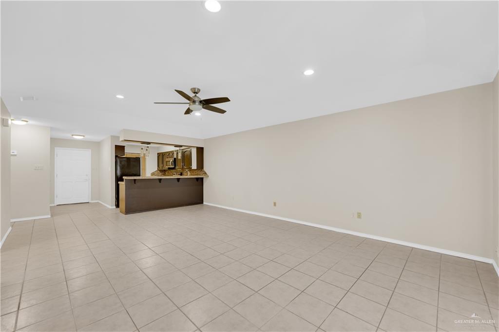 2401 South Jackson Road, Unit 9 Pharr, TX 78577 - Photo 4 of 17 a view of a livingroom with wooden floor and a ceiling fan