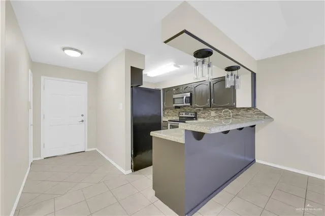a kitchen with stainless steel appliances granite countertop a sink and a stove