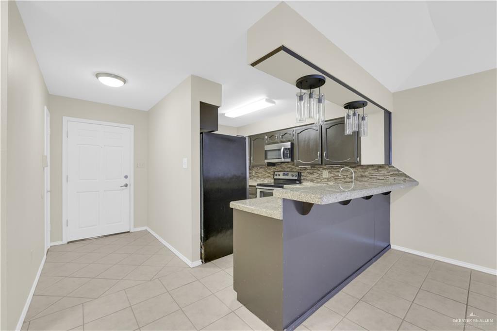 2401 South Jackson Road, Unit 9 Pharr, TX 78577 - Photo 7 of 17 a kitchen with stainless steel appliances granite countertop a sink and a stove