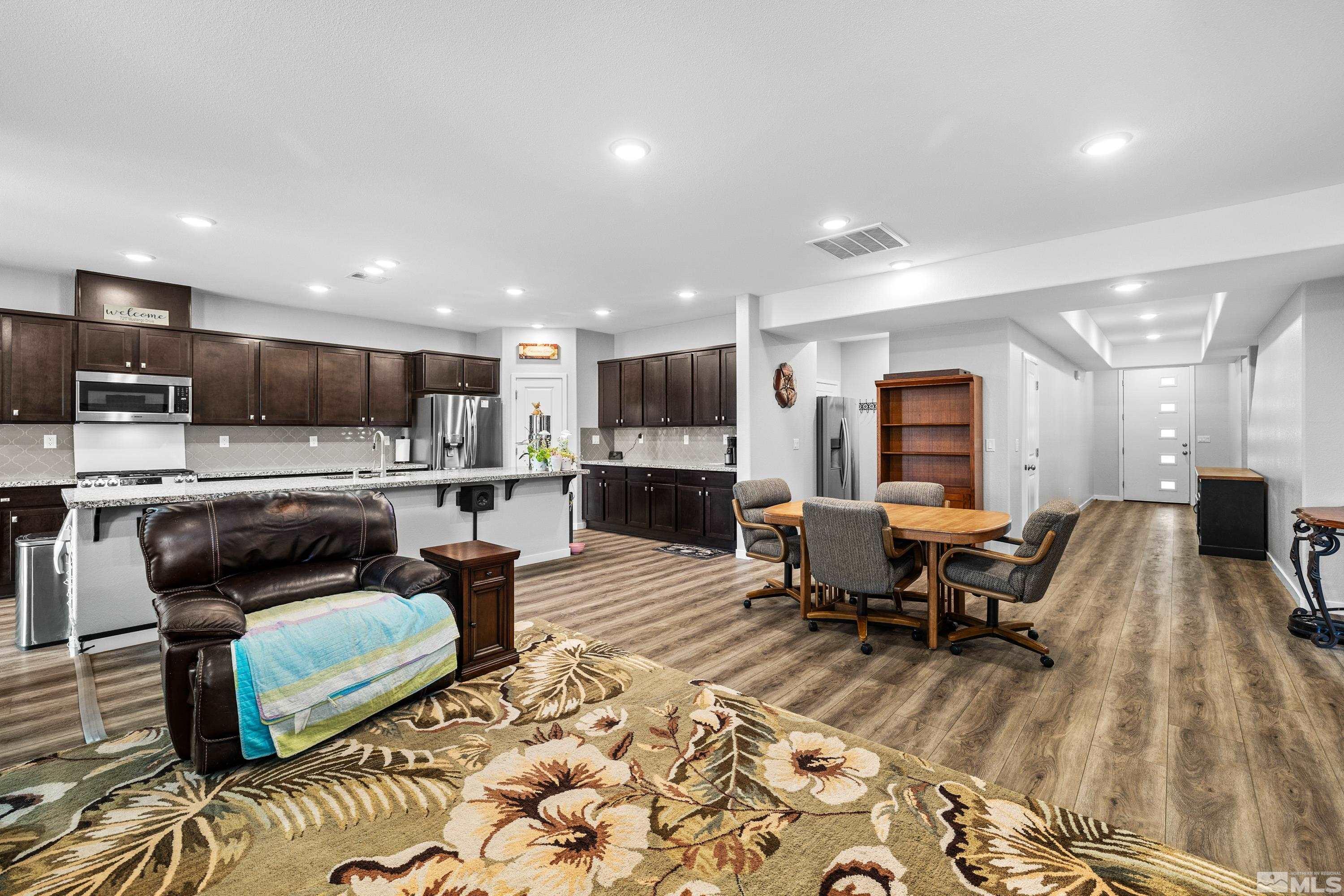 7217 Mustengo Drive Reno, NV 89506 - Photo 14 of 36 a living room with furniture and kitchen view