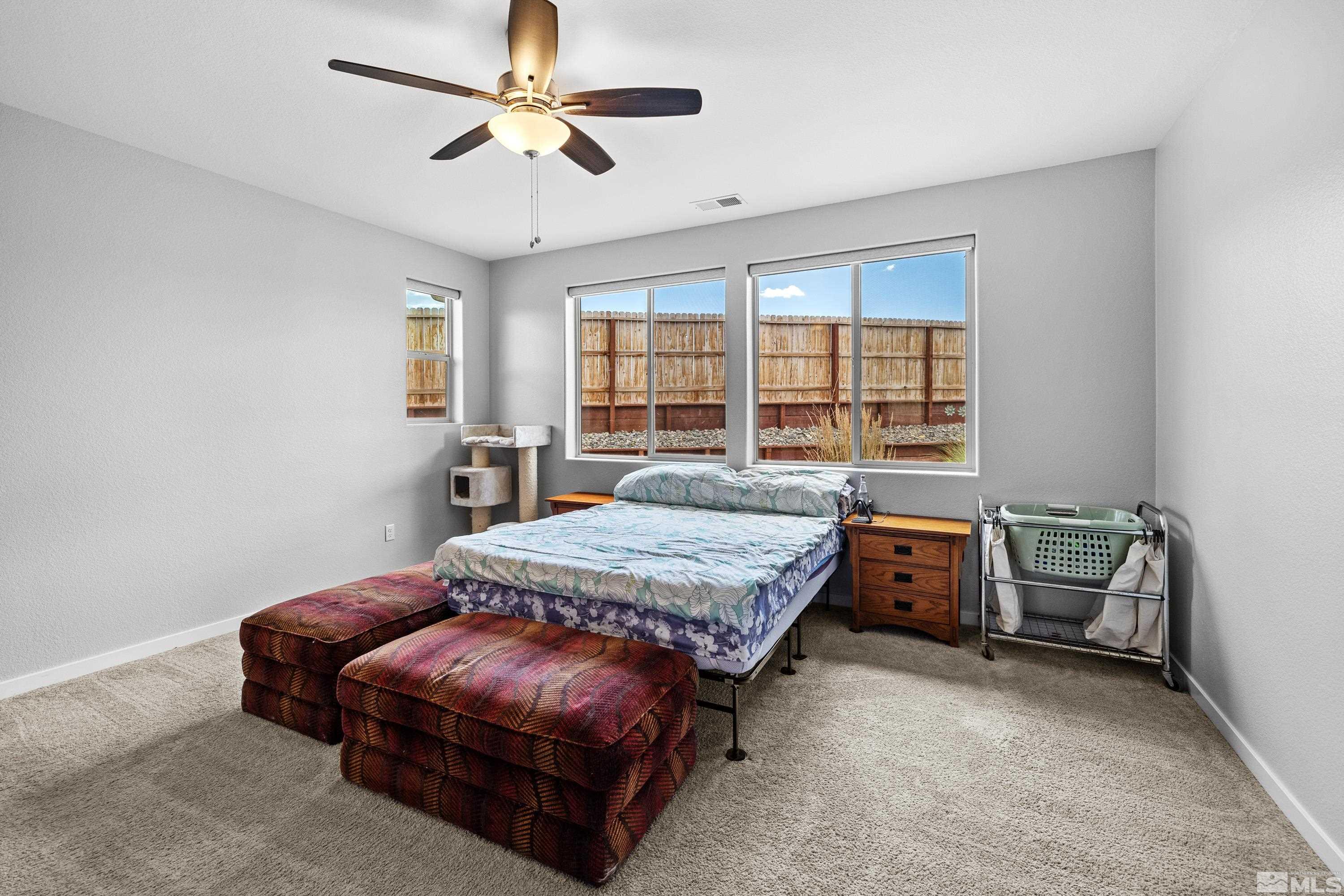 7217 Mustengo Drive Reno, NV 89506 - Photo 16 of 36 a bed room with a bed and a chair