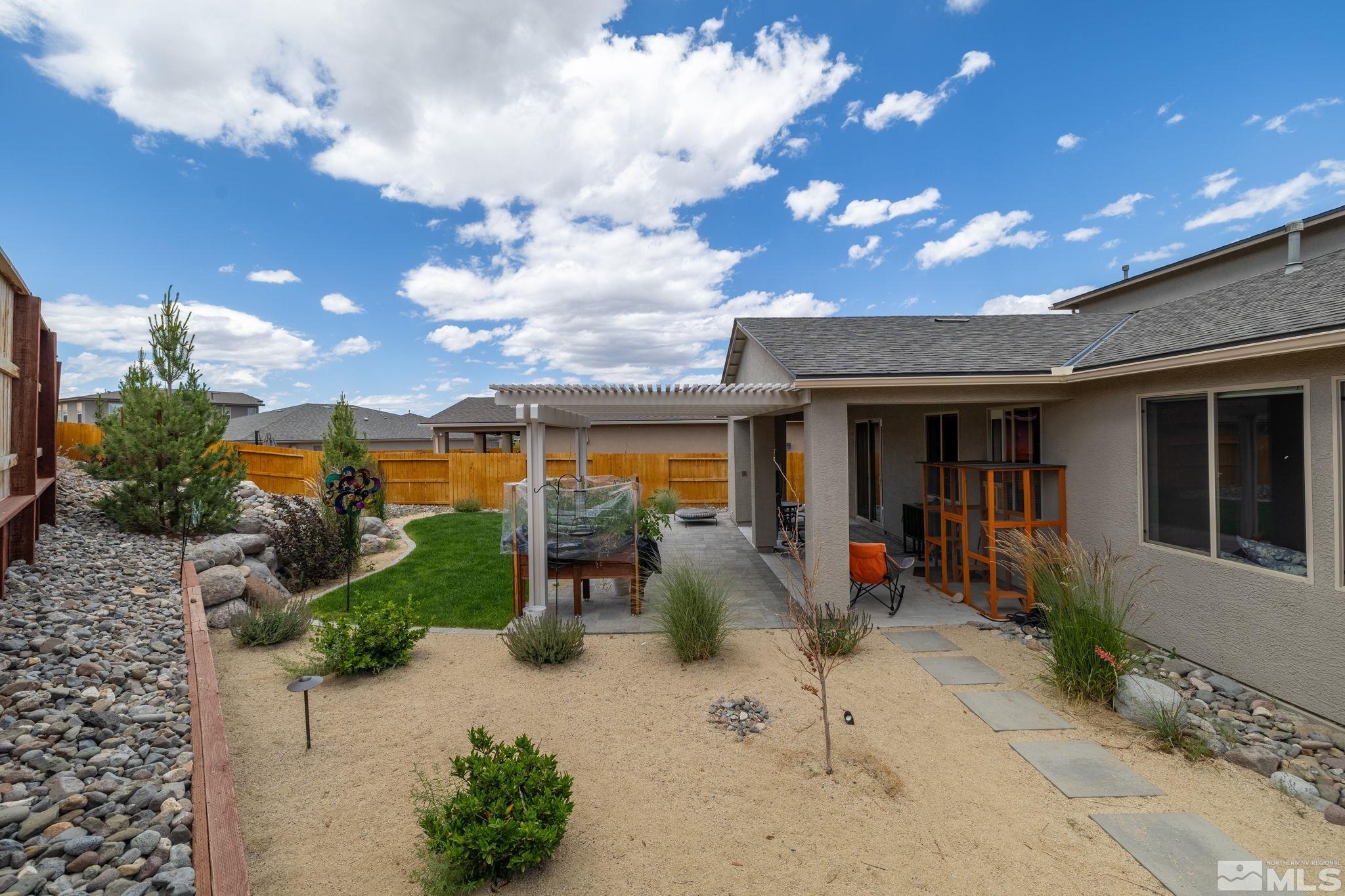 7217 Mustengo Drive Reno, NV 89506 - Photo 28 of 36 a view of a patio with table and chairs potted plants