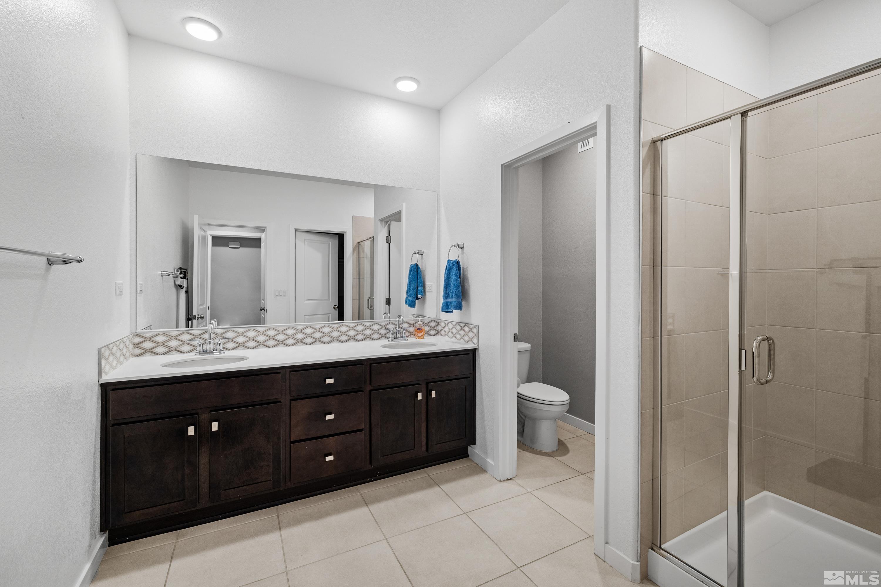7217 Mustengo Drive Reno, NV 89506 - Photo 6 of 36 a spacious bathroom with a granite countertop sink toilet and shower
