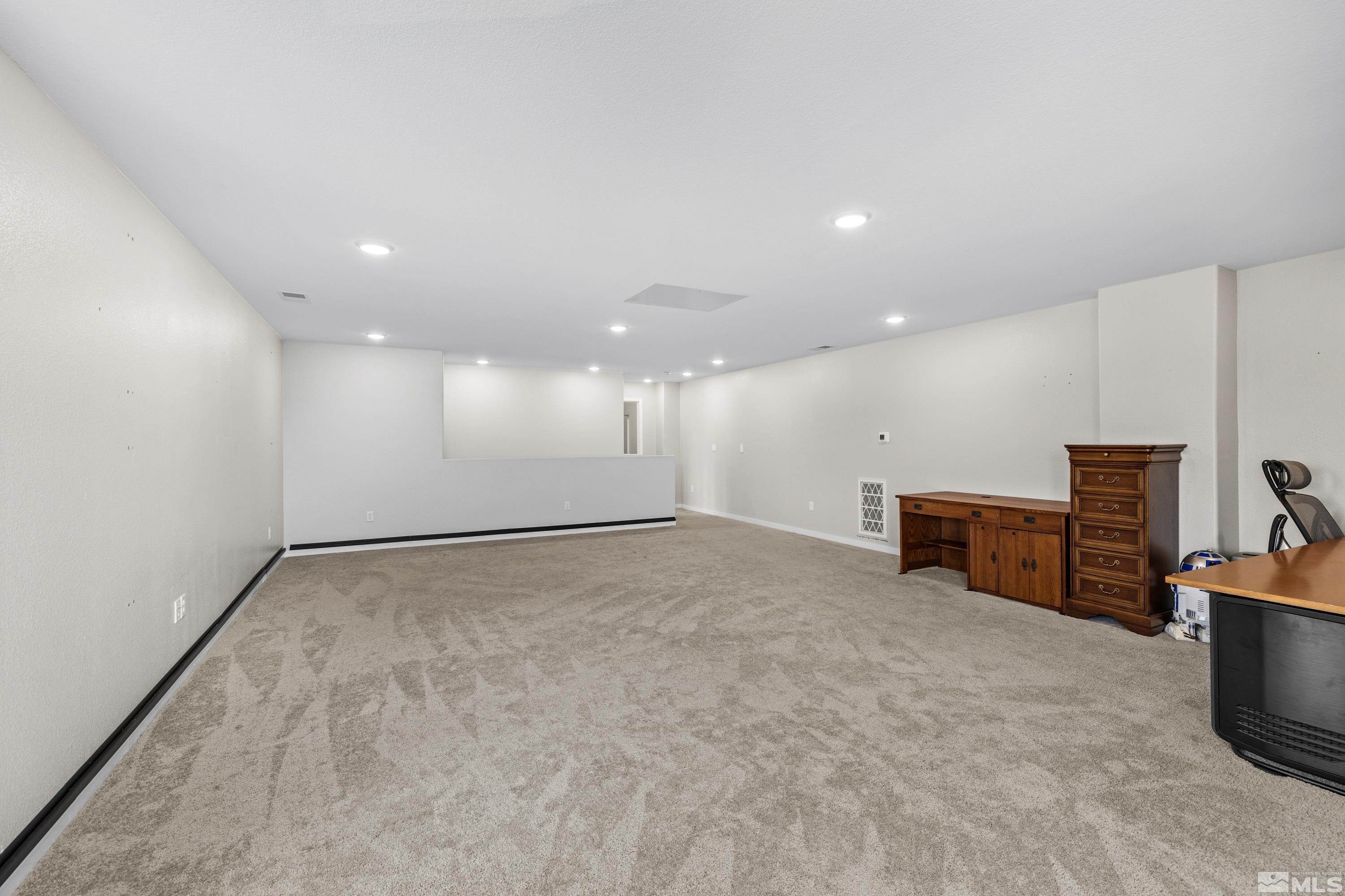 7217 Mustengo Drive Reno, NV 89506 - Photo 8 of 36 a view of empty room with wooden floor