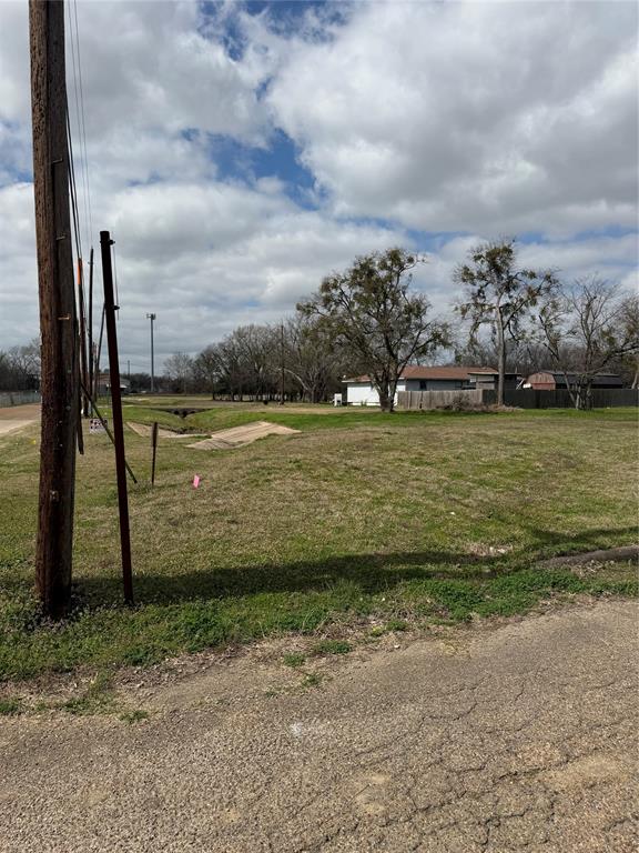 102 Johnson Street Commerce, TX 75428 - Photo 3 of 7 a view of a lake with a big yard