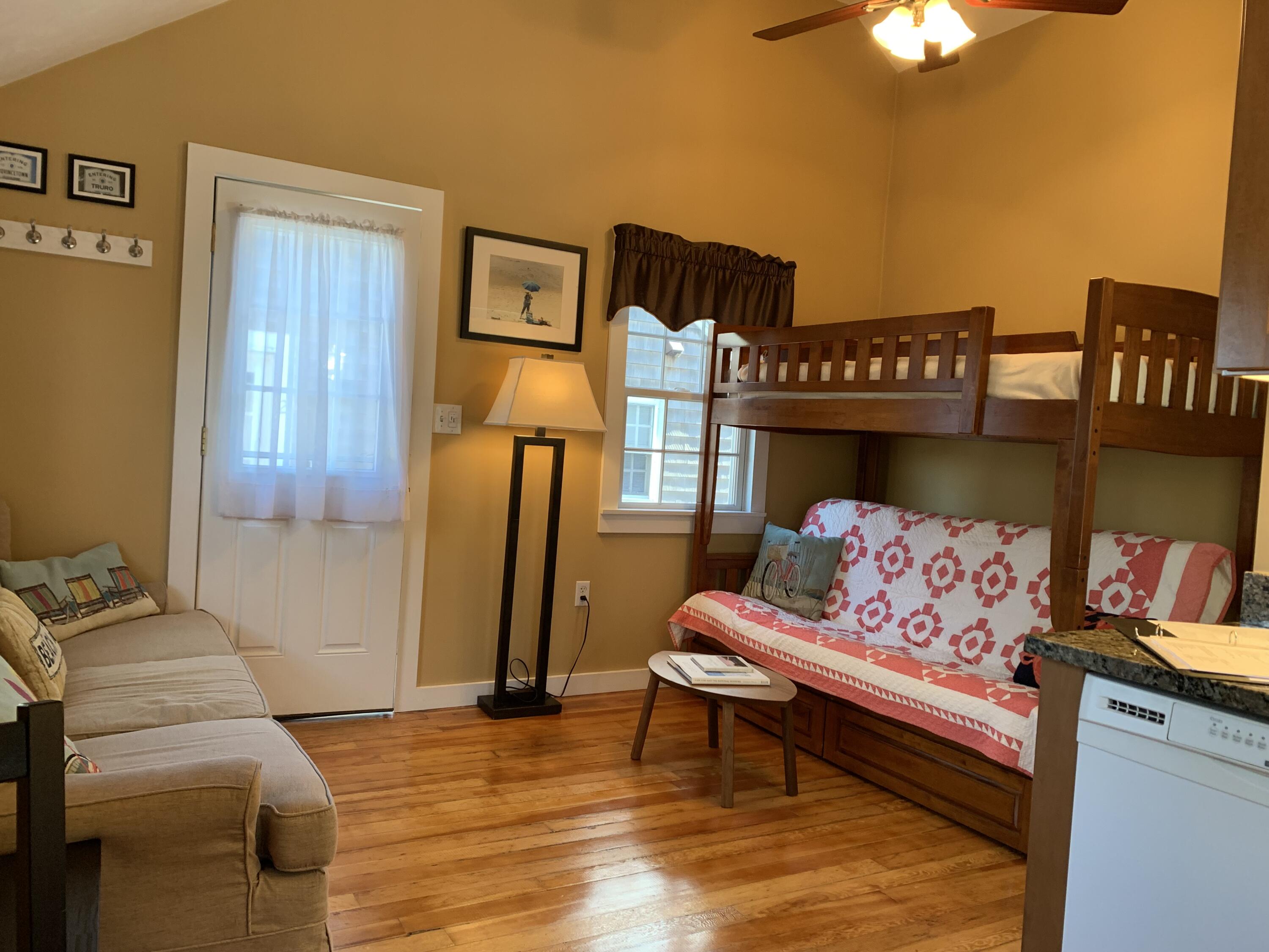 11 Hughes Road Truro, MA 02666 - Photo 6 of 34 a bedroom with furniture and a baby crib