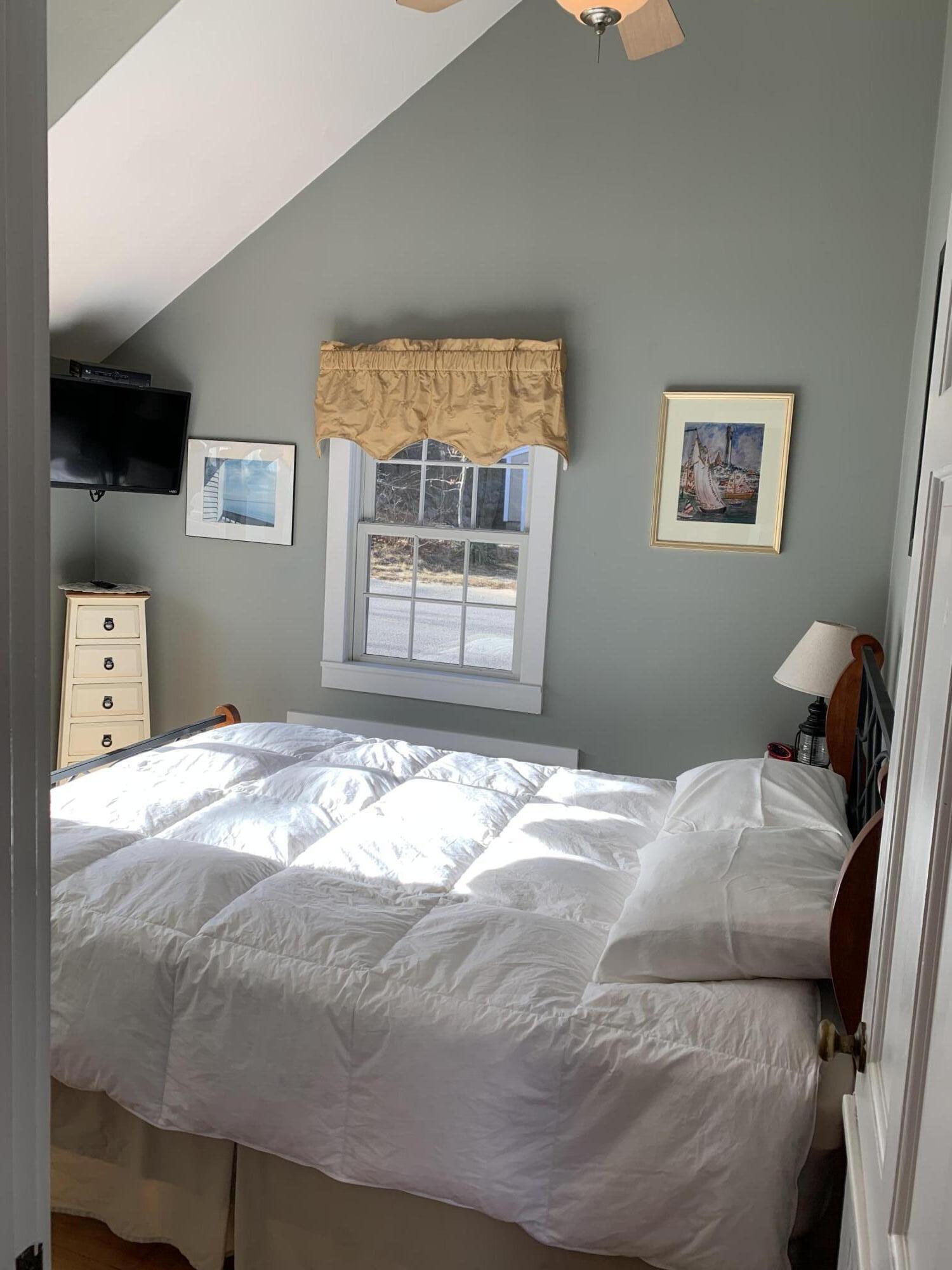 11 Hughes Road Truro, MA 02666 - Photo 8 of 34 a bed sitting in a bedroom next to a window