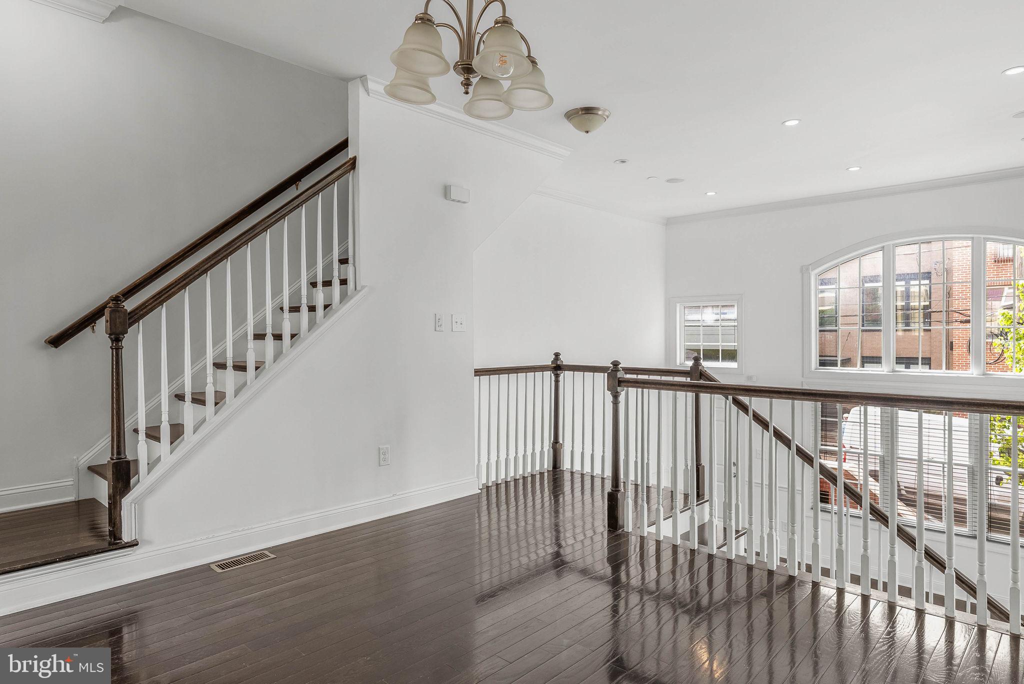 1015 North 3rd Street, Unit H Philadelphia, PA 19123 - Photo 4 of 27 a view of staircase with railing and a floor to ceiling window