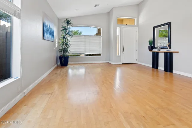 a view of a room with wooden floor and windows