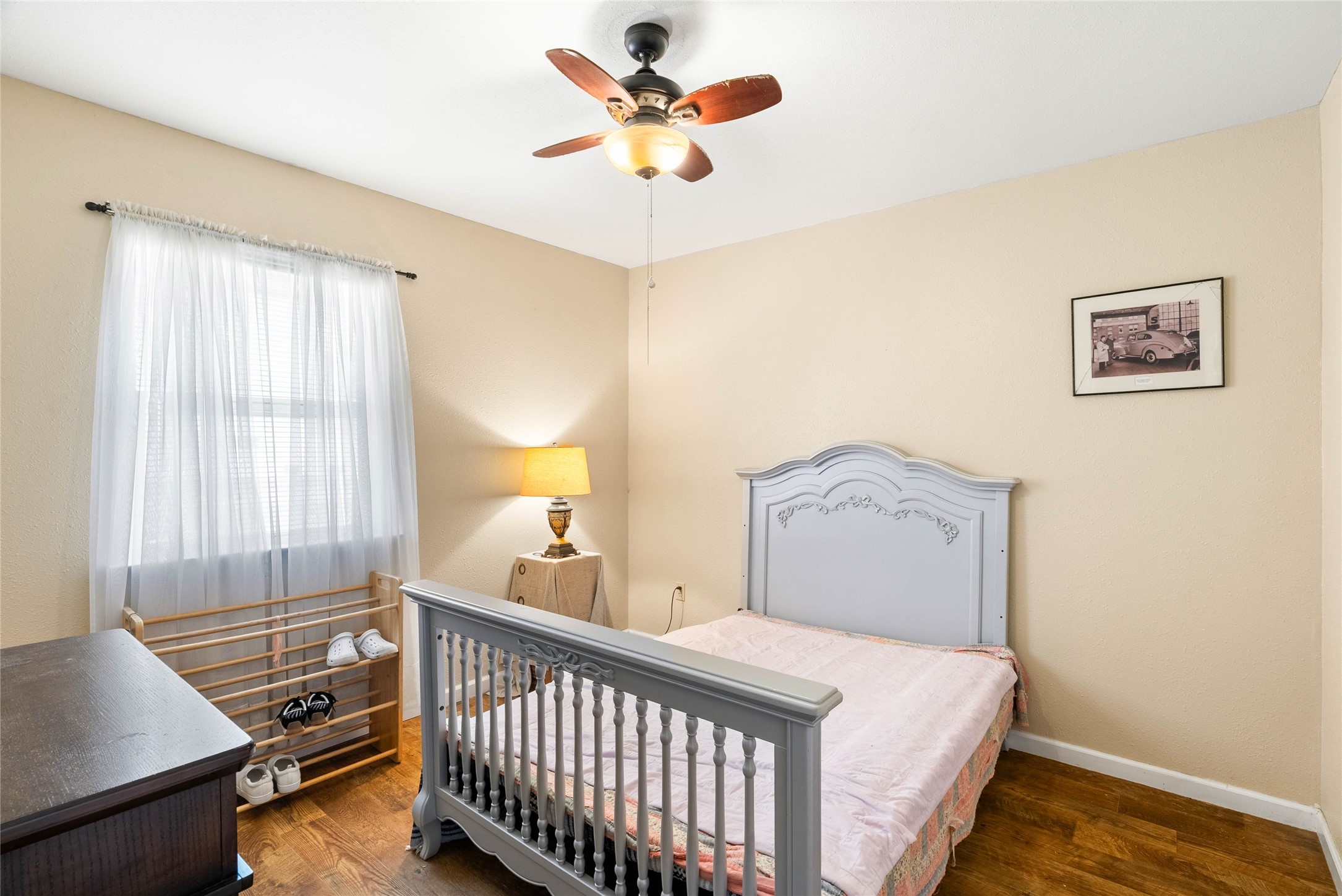 168 Sunset Ingleside, TX 78362 - Photo 13 of 26 Comfortable secondary bedroom featuring neutral tones, a large window, and cozy carpeting.