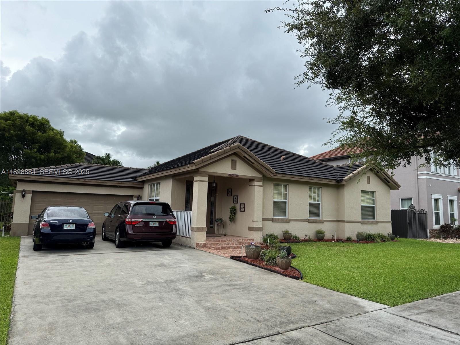 a car parked in front of house with a yard