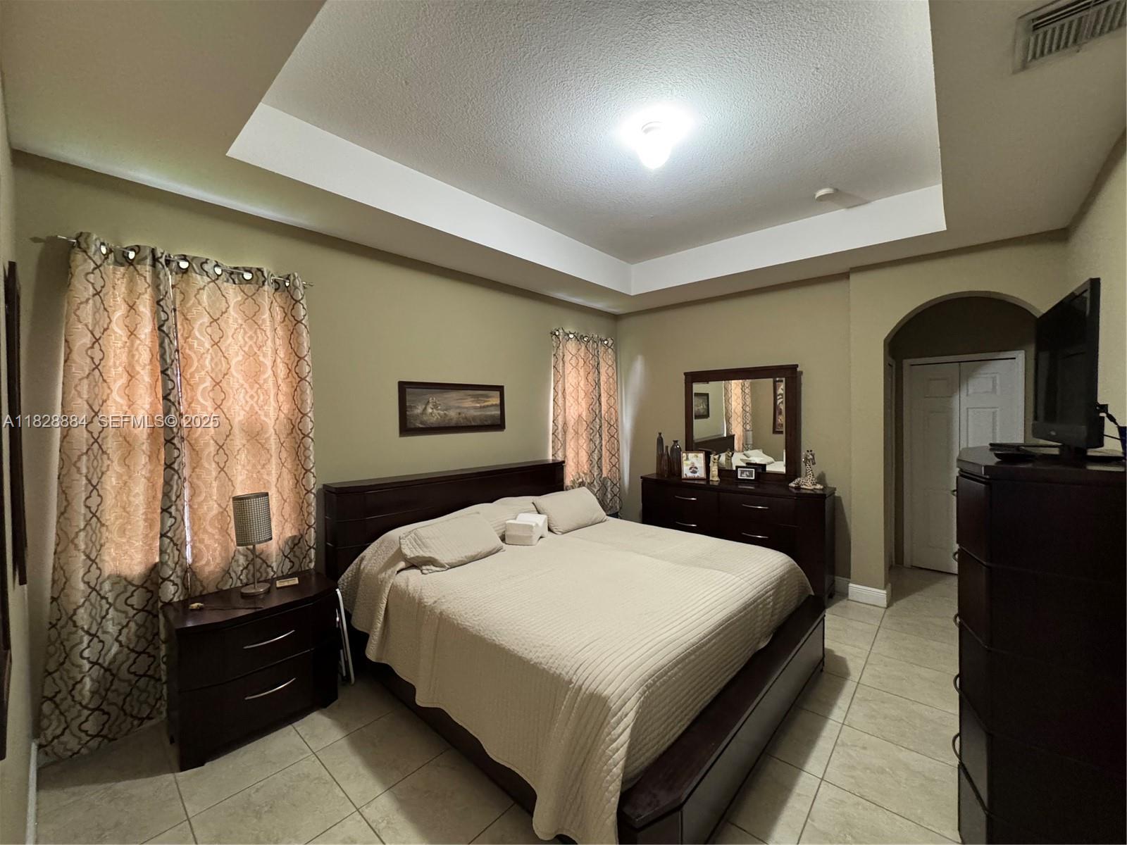 20233 Southwest 128th Place Miami, FL 33177 - Photo 14 of 21 a large bedroom with a bed and wooden floor