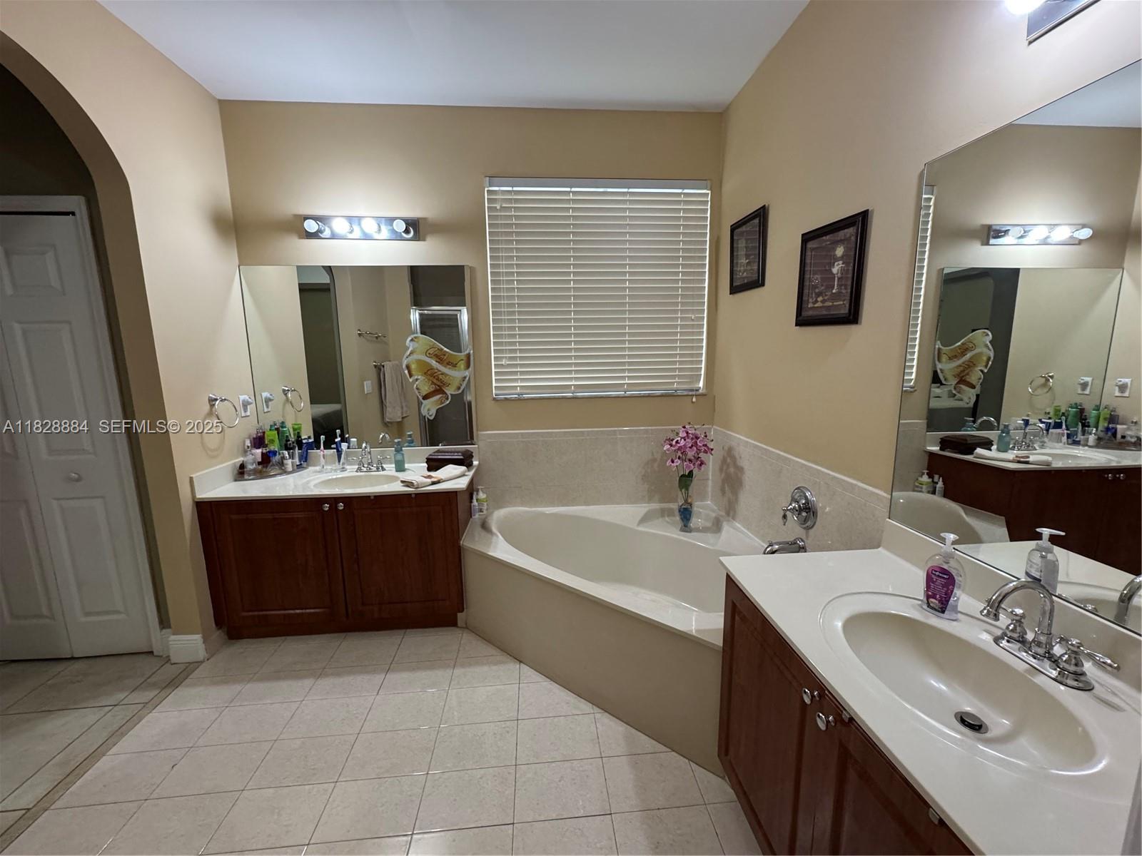 20233 Southwest 128th Place Miami, FL 33177 - Photo 16 of 21 a bathroom with a tub a sink and mirror