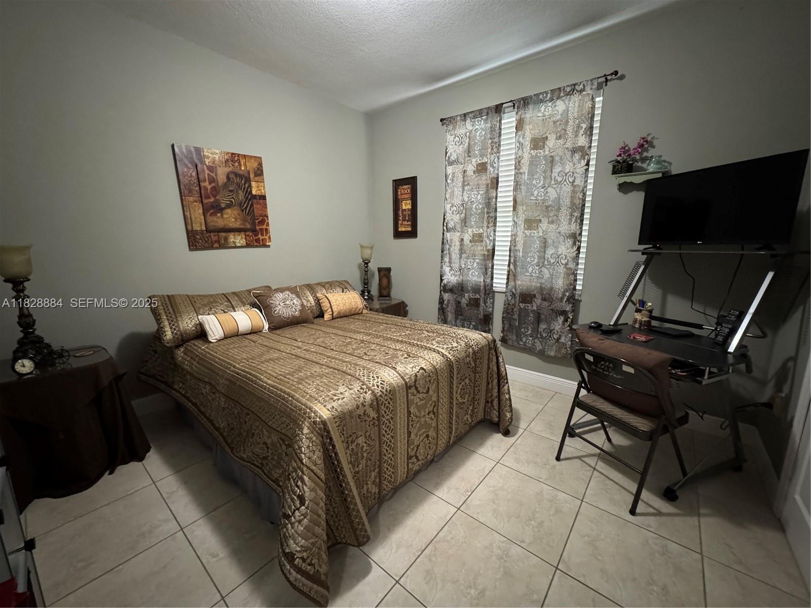 20233 Southwest 128th Place Miami, FL 33177 - Photo 17 of 21 a bedroom with a bed and a desk