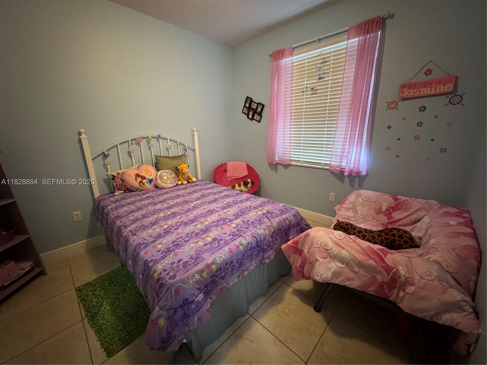 20233 Southwest 128th Place Miami, FL 33177 - Photo 18 of 21 a bedroom with two beds and a window