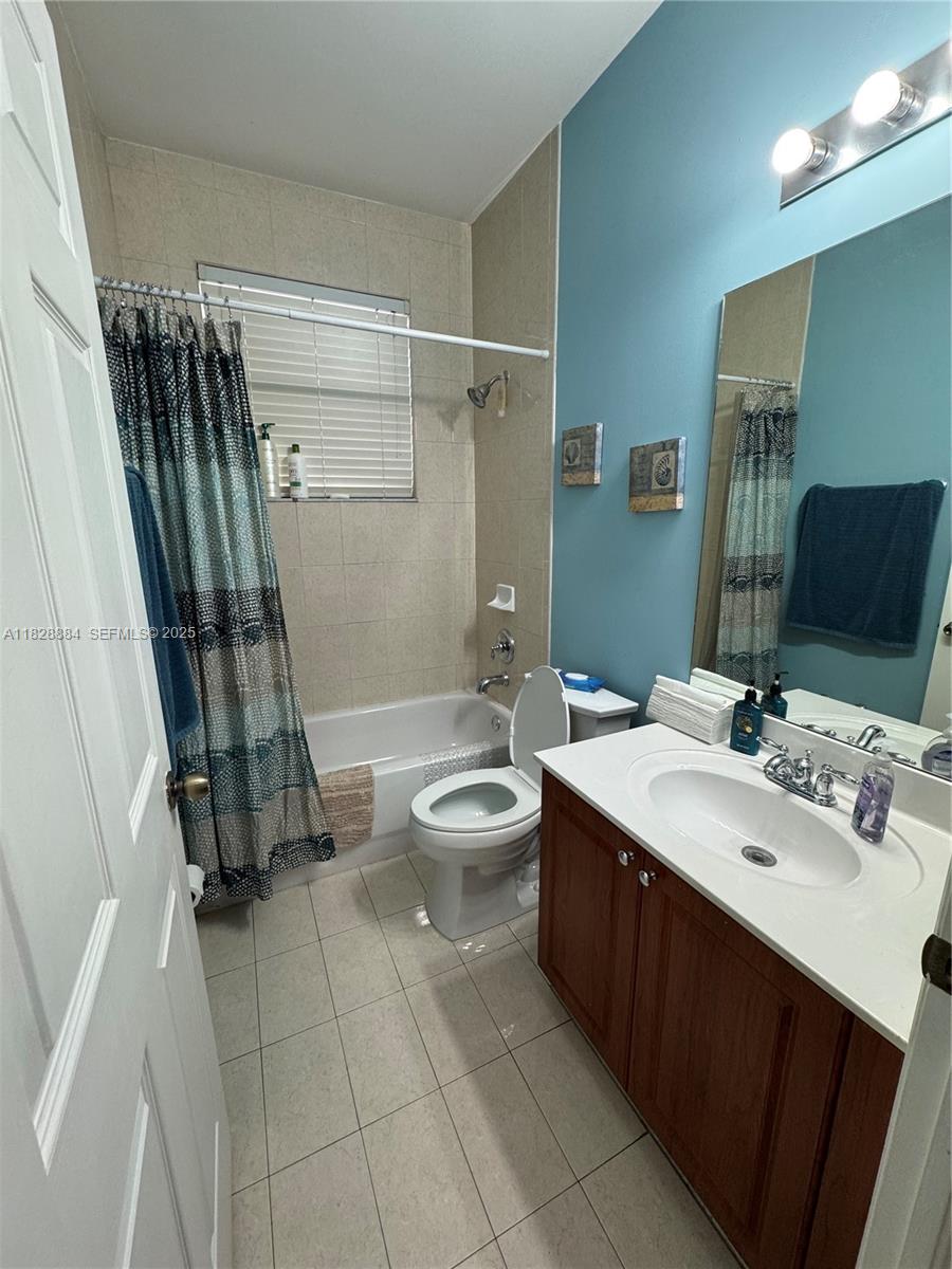 20233 Southwest 128th Place Miami, FL 33177 - Photo 20 of 21 a bathroom with a double vanity sink toilet and shower